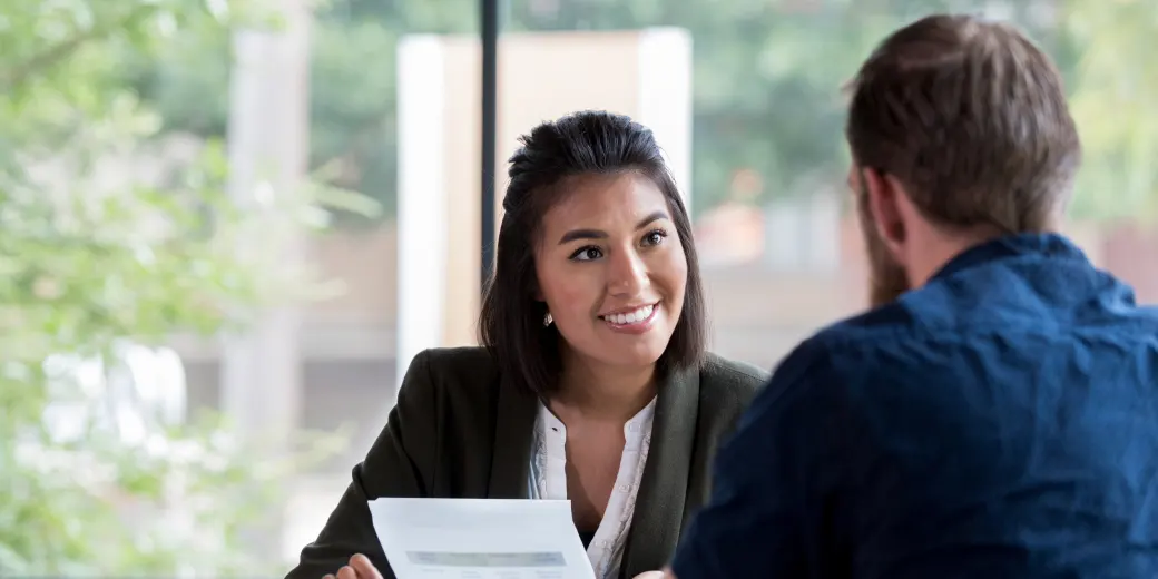 Man discussing finances with female teller