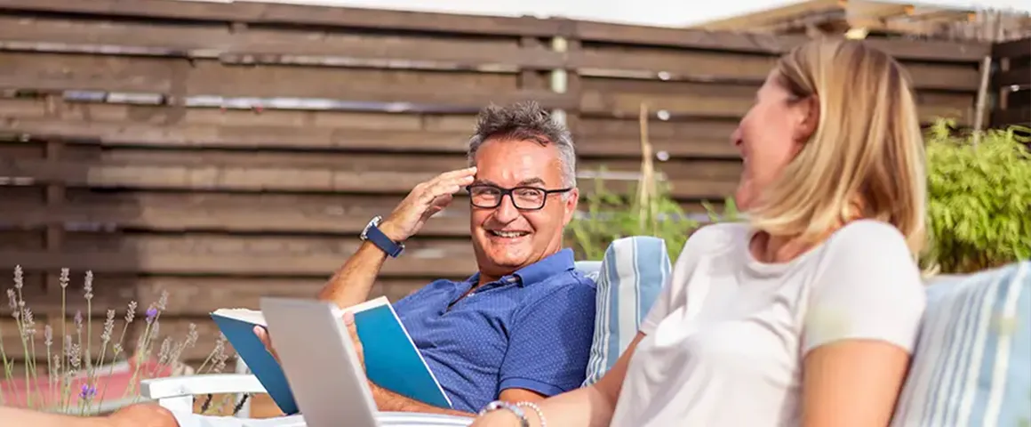 Smiling couple lounging in the backyard