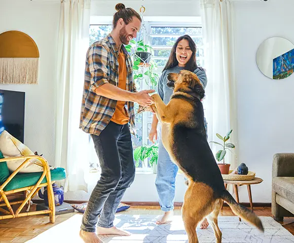 young couple dancing with a german shepherd